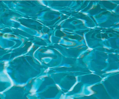 Leisure Pools fibreglass pool in Graphite Grey showing deep charcoal-toned water with blue sparkle.